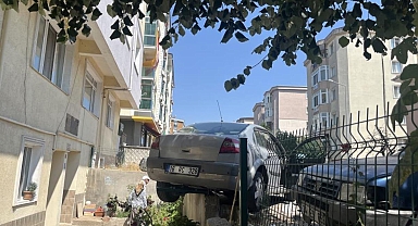 El frenini çekmeyi unuttu, otomobil bahçe duvarında asılı kaldı